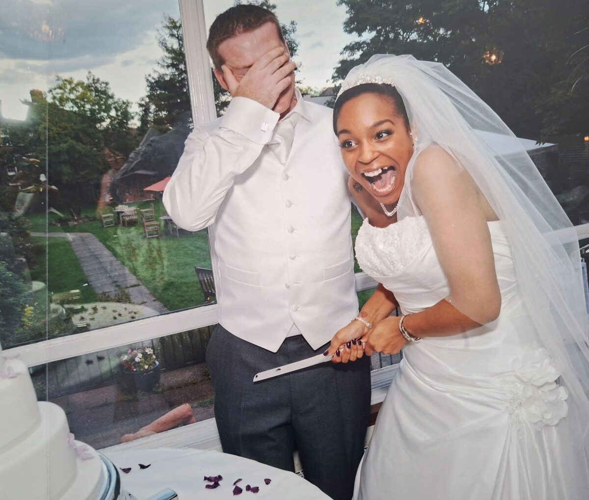 Tania in her strapless Sophia Tolli lace gown laughing with James during the cake cutting at The Clarendon Hotel, Blackheath.